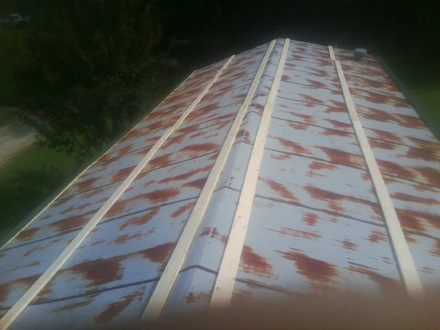 Rusted metal roof panels with new wood purlins before replacement — Storm Damage Roof Repair in Rodeo by Roofing Brothers